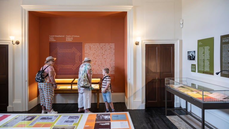 Visitors viewing the Castle of Culture exhibition at Newton House, Dinefwr, Carmarthenshire